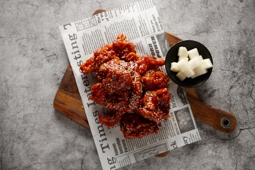 Sweet sour boneless chicken dish on table - Australian Stock Image