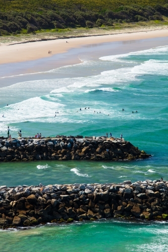 Swimmers and people spending time around the surf beach and mouth of the Evans River of Evans Head. - Australian Stock Image