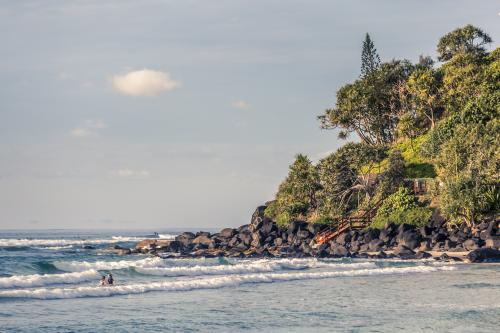 Swimmers in the waves at the beach. - Australian Stock Image