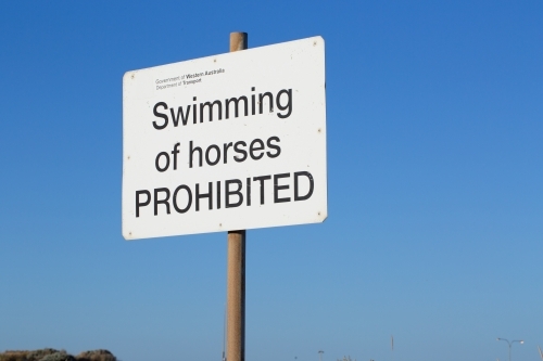 swimming of horses prohibited sign near beach - Australian Stock Image