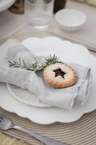 Table setting with mince pie on plate - Australian Stock Image