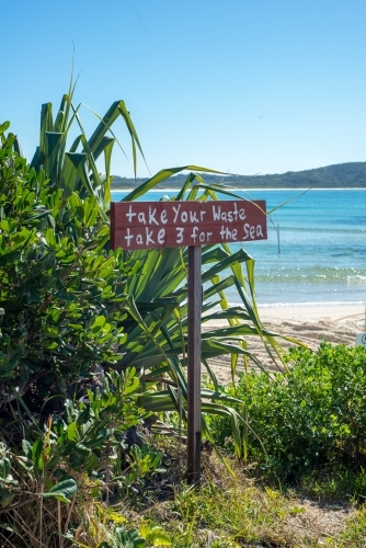 Take your Rubbish sign on coastline with beach in background - Australian Stock Image