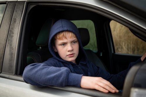 Teen boy driving ute on farm - Australian Stock Image