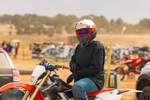 Teen boy riding motorbike at motocross track meet - Australian Stock Image