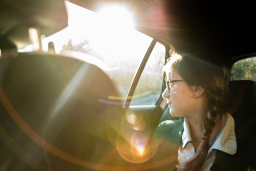 teen in school uniform, being driven to school in the morning - Australian Stock Image