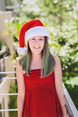 teen in xmas hat and dress - Australian Stock Image