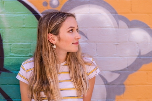 teen leaning against wall - Australian Stock Image