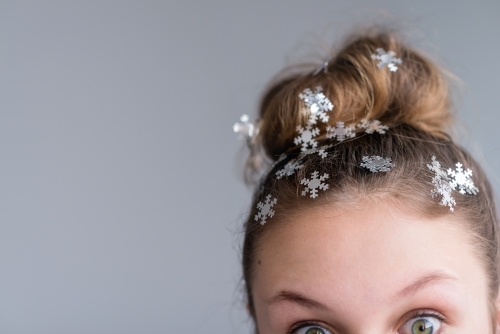 teen with hair bun and snowflakes