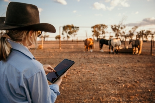 Teenage female holding ipad in outback Australia - Australian Stock Image