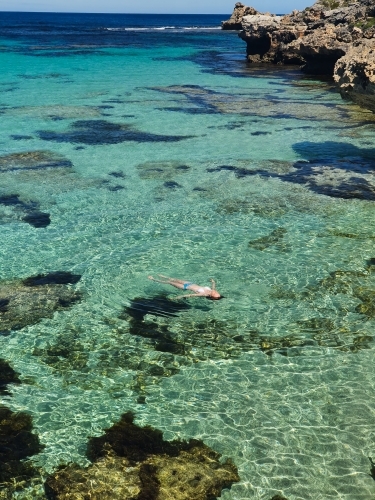 Teenage girl floating in the ocean - Australian Stock Image
