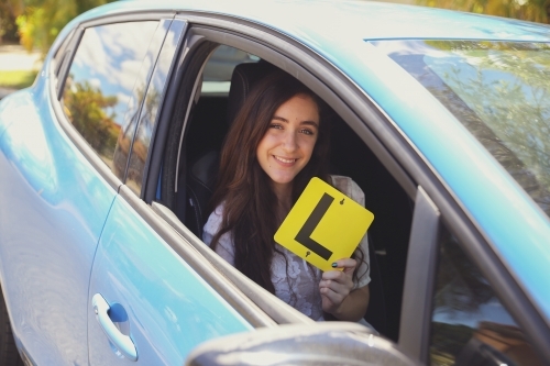 Teenage girl holding L plate - Australian Stock Image