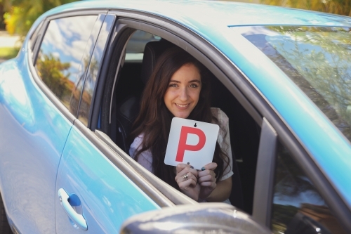 Teenage girl holding P plate - Australian Stock Image