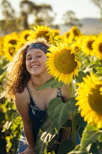 Teenage girl smiling in sunflower field