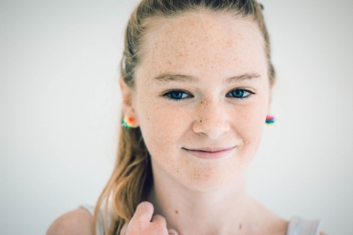 Teenage girl with freckles smiling