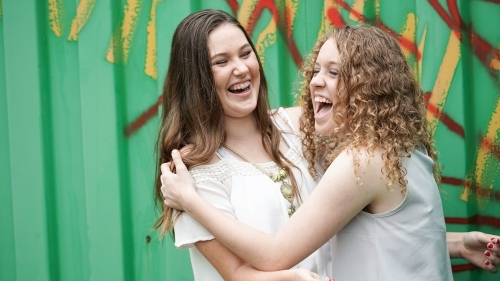 Teenager girls laughing together - Australian Stock Image