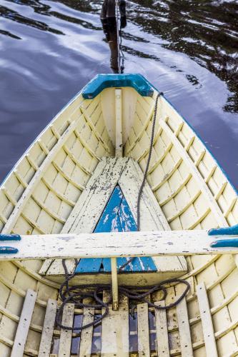 The bow of a wooden boat on the water. - Australian Stock Image