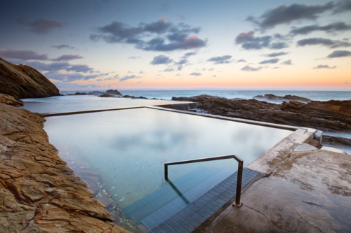 The iconic and famous Blue Pool on a cool autumn evening in Bermagui, New South Wales, Australia - Australian Stock Image