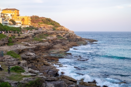 the last rays of the sun, shining on the houses on the cliffs edge of Tamarama - Australian Stock Image