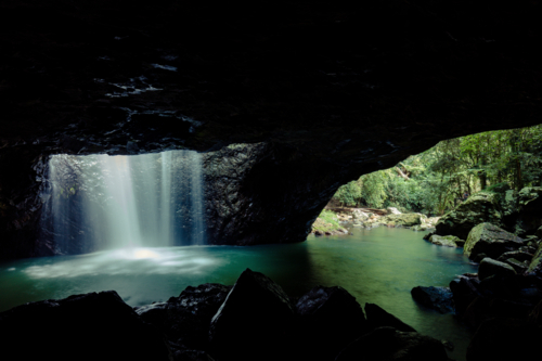 The majestic and iconic Natural Bridge on a warm autumn day in Springbrook National Park - Australian Stock Image