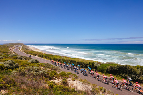 The peloton rides past 13th Beach during the 2024 Men's Elite Cadel Evans Great Ocean Road Race. - Australian Stock Image