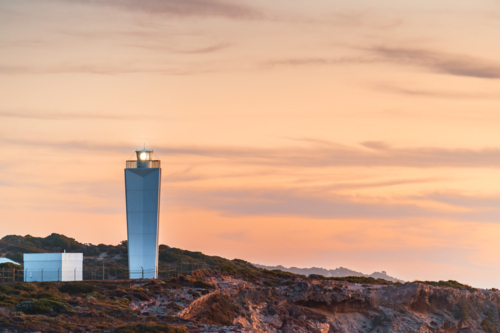 The Robe Lighthouse at sunset on the western edge of the Robe township. - Australian Stock Image