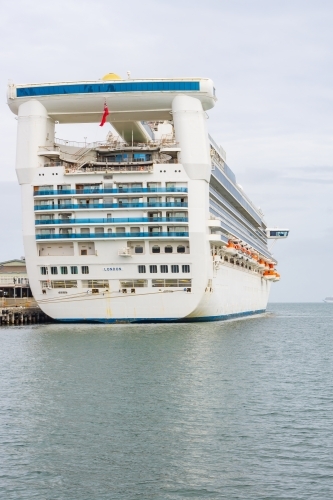 The stern of a large cruise ship docked at shipping terminal - Australian Stock Image