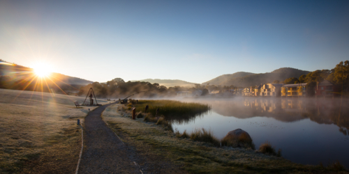 The sun rises over Lake Crackenback on a cold autumn morning in New South Wales, Australia - Australian Stock Image