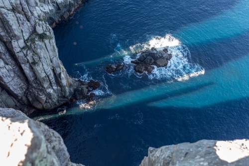 The view from Tasmania's Cape Hauy on the Three Capes Track of swell crashing against the rocks - Australian Stock Image