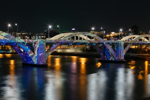 The William Jolly Bridge illuminated at night by projected colours and patterns. Brisbane city. - Australian Stock Image