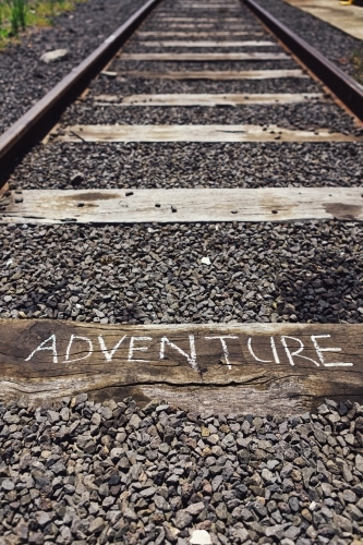 The word adventure written on a railway track sleeper - Australian Stock Image