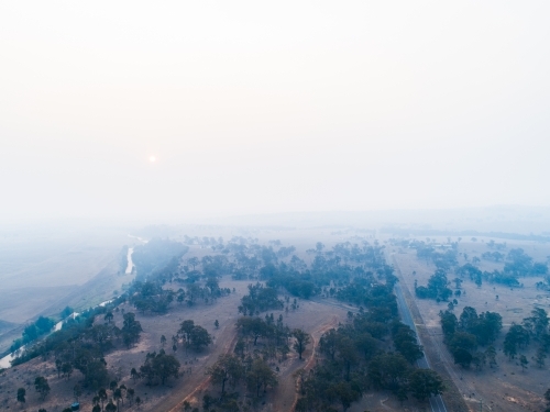 Thick smoke haze over farmland in hunter valley from bushfires - Australian Stock Image