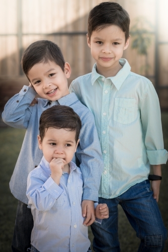 Three brothers in a suburban home backyard - Australian Stock Image