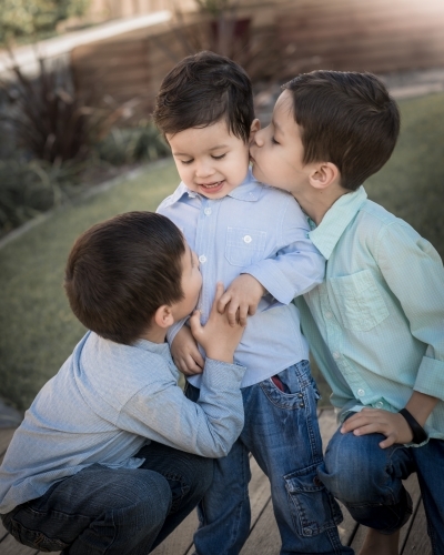 Three brothers in a suburban home backyard - Australian Stock Image