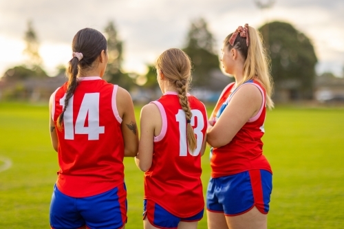three female teammates in football uniforms at training - Australian Stock Image