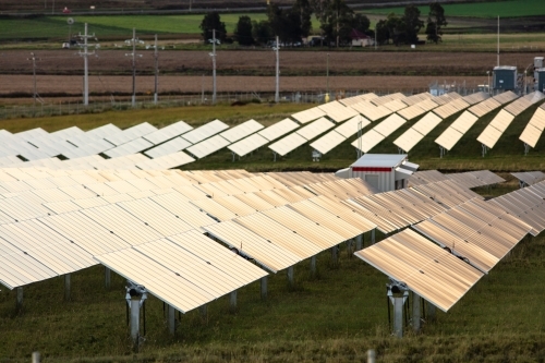 Tilting solar farm panels outside of Warwick at sunset - Australian Stock Image