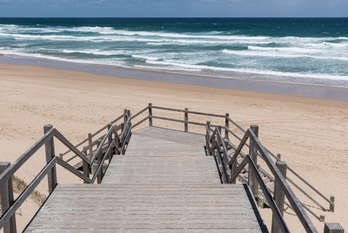 timber stairs leading onto the sand back beach - Australian Stock Image