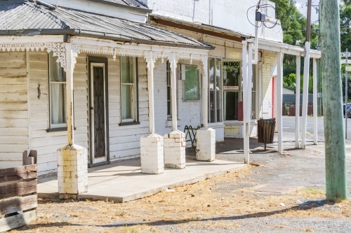 Tin roof verandas and posts of old weatherboard houses - Australian Stock Image