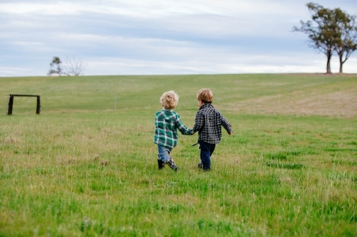 Todders holding hands - Australian Stock Image