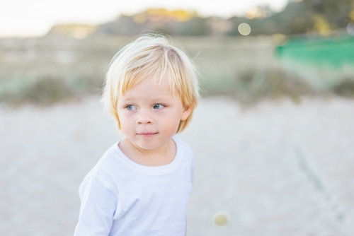 Toddler boy exploring Gold Coast beach - Australian Stock Image