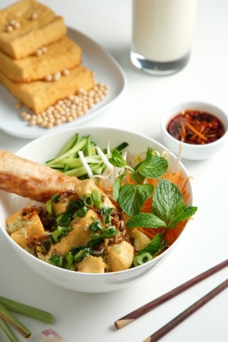 Tofu Bun Cha Gio bowl with topped with fried spring roll. - Australian Stock Image