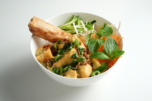 Tofu Bun Cha Gio bowl with topped with fried spring roll. - Australian Stock Image