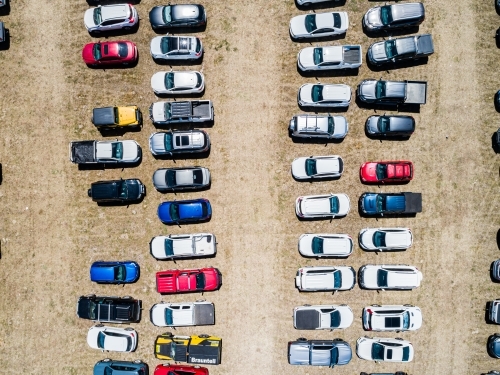 Top down aerial photo of cars in overflow parking in paddock during sport event - Australian Stock Image