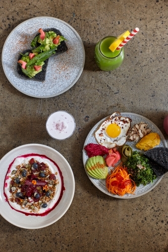 Top down of healthy vegetarian meals and juices - Australian Stock Image