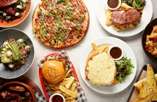 Top down shot of various restaurant dishes - Australian Stock Image