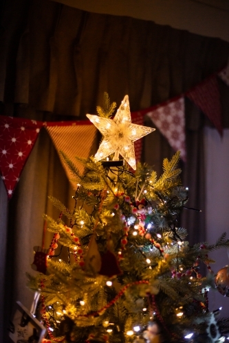 top of a christmas tree with a light up star - Australian Stock Image