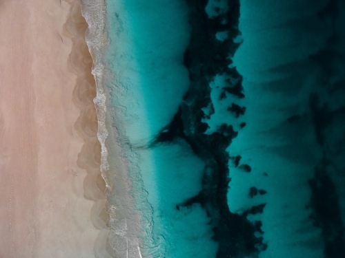 top shot of Summers in Perth with white sand, green grass and ocean water - Australian Stock Image