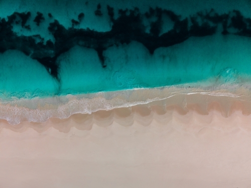 top shot of Summers in Perth with white sand, waves. and ocean water - Australian Stock Image