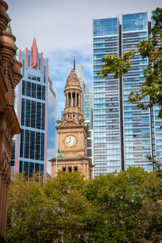 Town Hall clock tower with modern buildings behind it - Australian Stock Image
