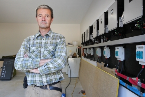 Tradesman at work in off grid house - Australian Stock Image