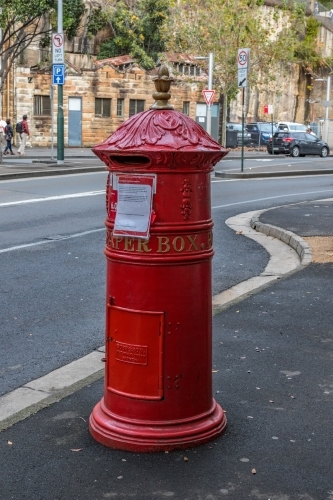 Traditional red postal mail box on city street in Sydney